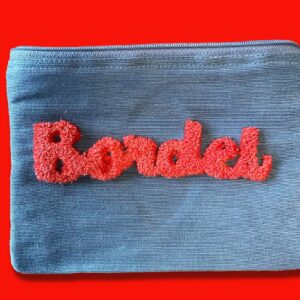 Petite pochette bleue ciel en toile de jute et coton, broderie punch needle "Bordel" fils DMC rouge by broc into the moon